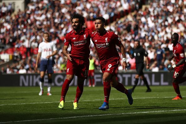 Salah (left), Firmino (centre) and Mane (back, right) wheel away to celebrate during Liverpool's Premier League win over Spurs