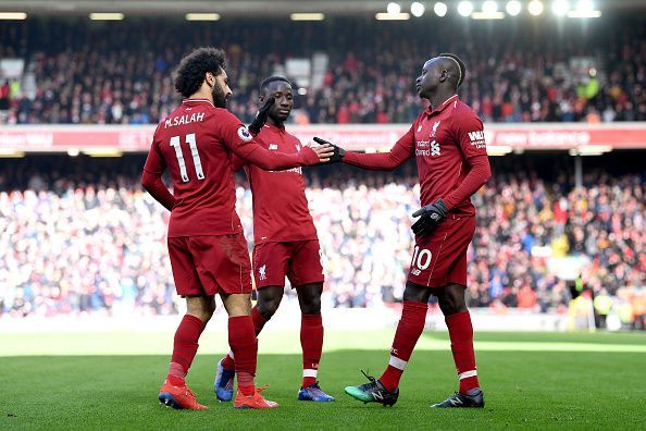 Mane (far right) celebrates his second goal with Salah and substitute Keita during their win