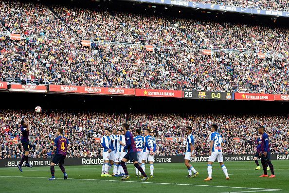 Messi watches his audacious free-kick as it floats goalwards to break the deadlock against Espanyol