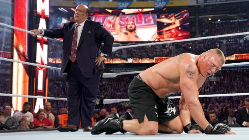  ] Brock Lesnar and Paul Heyman look shaken after Lesnar's defeat of Seth Rollins 