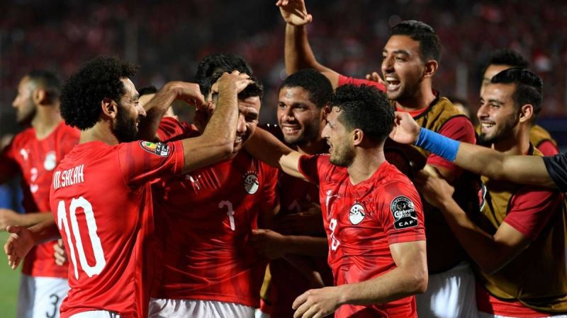 Egyptian players congratulating Trezeguet for his remarkable goal