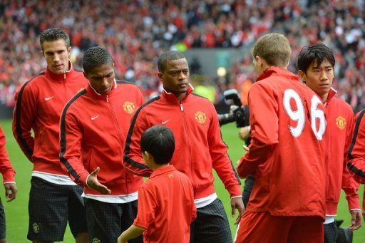 Manchester United defender Patrice Evra (3rd L) waits to shakes hands with Liverpool's Steven Gerrard (2nd right) Manchester United defender Patrice Evra (3rd L) waits to shakes hands with Liverpool's Steven Gerrard (2nd right)