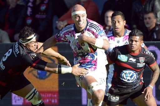 Stade Francais's Scott Lavalla (C) tries to break past RC Toulon's Number 8 Chris Masoe (L) and winger David Smith (R) Stade Francais's Scott Lavalla (C) tries to break past RC Toulon's Number 8 Chris Masoe (L) and winger David Smith (R)