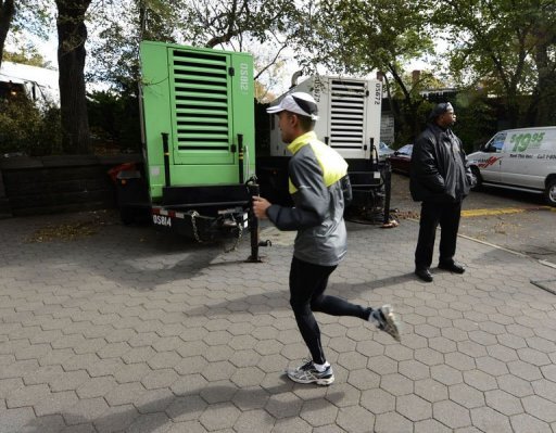 A runner passes by portable generators near the finish Line of the New York City Marathon A runner passes by portable generators near the finish Line of the New York City Marathon