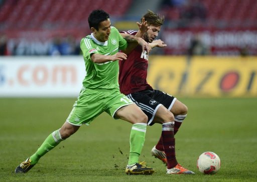 Wolfsburg' midfielder Hakoto Hasebe (L) and Nuremberg's defender Marvin Plattenhardt fight for the ball Wolfsburg' midfielder Hakoto Hasebe (L) and Nuremberg's defender Marvin Plattenhardt fight for the ball