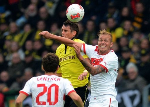 Dortmund's midfielder Sebastian Kehl (C) and Stuttgart's midfielder Raphael Holzhauser (R) jump for the ball Dortmund's midfielder Sebastian Kehl (C) and Stuttgart's midfielder Raphael Holzhauser (R) jump for the ball