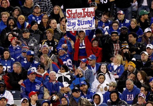 A fan holds a sign of encouragement for the Staten Island Borough of New York City A fan holds a sign of encouragement for the Staten Island Borough of New York City