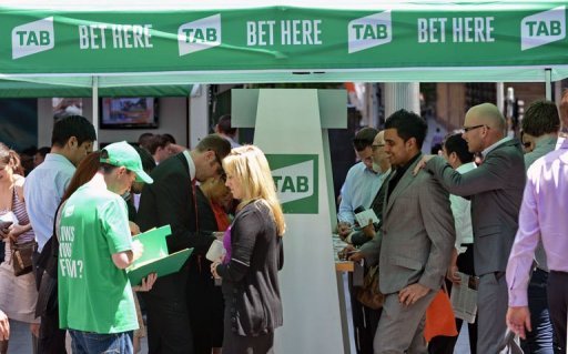 People stand outside a tent set up as a betting booth for the Melbourne Cup horse race in Sydn People stand outside a tent set up as a betting booth for the Melbourne Cup horse race in Sydn
