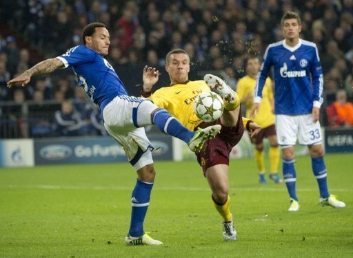 Arsenal's Lucas Podolski (C) and Schalke's Jermaine Jones (L) fight for the ball Arsenal's Lucas Podolski (C) and Schalke's Jermaine Jones (L) fight for the ball