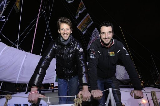 Lotus F1 Team's driver Romain Grosjean (L) and French skipper Louis Burton are seen on the monohull 'Bureau Vallee' Lotus F1 Team's driver Romain Grosjean (L) and French skipper Louis Burton are seen on the monohull 'Bureau Vallee'