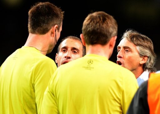 Roberto Mancini confronts the referee on the pitch at the end of the City's draw with Ajax on Tuesday Roberto Mancini confronts the referee on the pitch at the end of the City's draw with Ajax on Tuesday