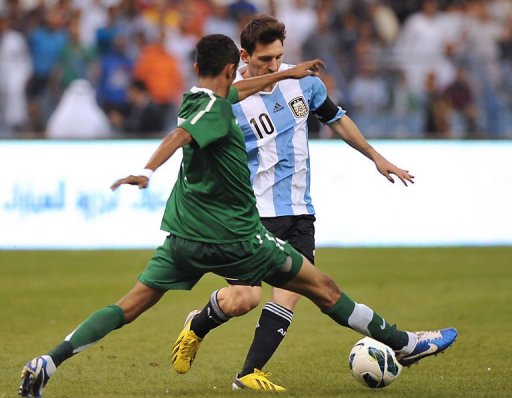Saudi Arabia's Salman al-Faraj challenges Argentina's forward Lionel Messi (back) Saudi Arabia's Salman al-Faraj challenges Argentina's forward Lionel Messi (back)