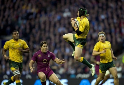 Australia's full back Berrick Barnes (2nd R) jumps to catch the ball Australia's full back Berrick Barnes (2nd R) jumps to catch the ball