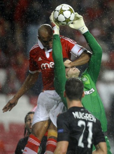 Celtic's English goalkeeper Fraser Forster catches the ball past Benfica's Brazilian defender Celtic's English goalkeeper Fraser Forster catches the ball past Benfica's Brazilian defender