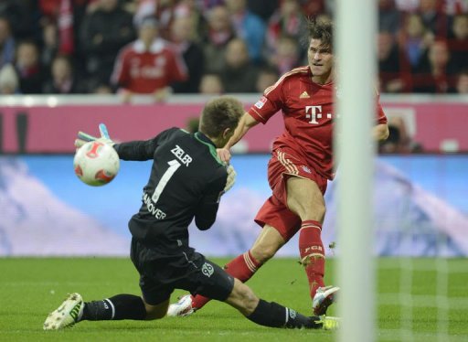 Bayern Munich's striker Mario Gomez (R) scores the fifth goal for Munich against Hanover's goalkeeper Ron-Robert Zieler Bayern Munich's striker Mario Gomez (R) scores the fifth goal for Munich against Hanover's goalkeeper Ron-Robert Zieler