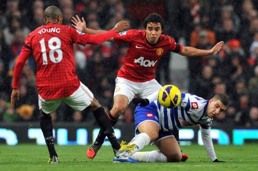 Manchester United's Brazilian defender Rafael (C) and English forward Ashley Young (L) challenge QPR's Adel Taarabt Manchester United's Brazilian defender Rafael (C) and English forward Ashley Young (L) challenge QPR's Adel Taarabt