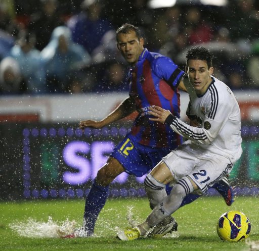 Levante's Juanfran Garcia (L) fights for the ball with Real Madrid's Jose Maria Callejon Levante's Juanfran Garcia (L) fights for the ball with Real Madrid's Jose Maria Callejon