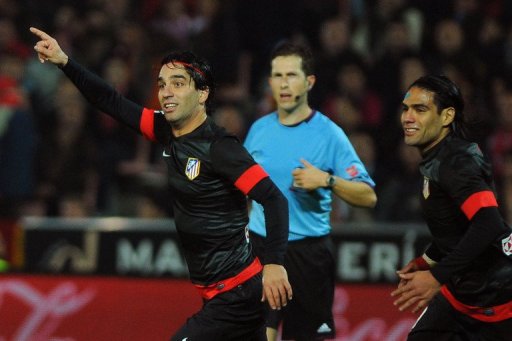 Atletico Madrid's Arda Turan (L) celebretes with teammate Radamel Falcao after scoring against Granada Atletico Madrid's Arda Turan (L) celebretes with teammate Radamel Falcao after scoring against Granada