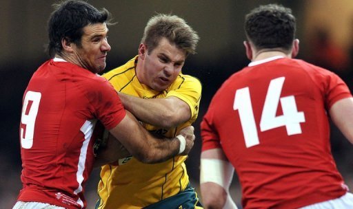 Australia's wing Drew Mitchell (centre) is tackled by Wales's scrum half Mike Phillips (left) and wing Alex Cuthbert Australia's wing Drew Mitchell (centre) is tackled by Wales's scrum half Mike Phillips (left) and wing Alex Cuthbert