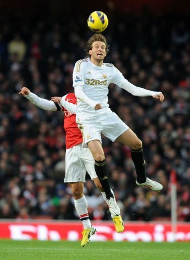 Swansea City's midfielder Miguel Michu (R) beats Arsenal's defender Thomas Vermaelen (L) for a high ball Swansea City's midfielder Miguel Michu (R) beats Arsenal's defender Thomas Vermaelen (L) for a high ball