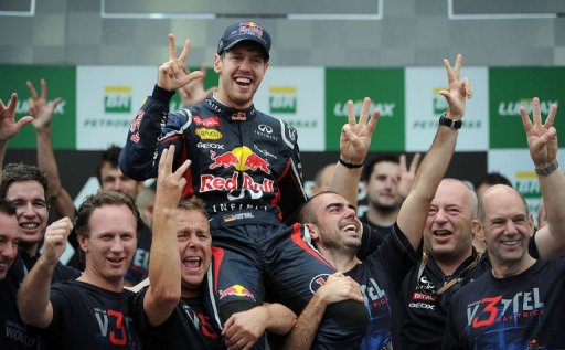 German Formula One driver Sebastian Vettel (C) celebrates his F-1 World Championship with members of the Red Bull team German Formula One driver Sebastian Vettel (C) celebrates his F-1 World Championship with members of the Red Bull team