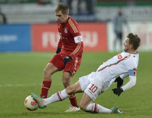 Bayern Munich's defender Philipp Lahm (L) and Augsburg's midfielder Daniel Baier challenge for the ball Bayern Munich's defender Philipp Lahm (L) and Augsburg's midfielder Daniel Baier challenge for the ball