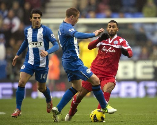 Wigan Athletic's James McCarthy (C) fights for the ball against Queens Park Rangers' Armand Traore (R) Wigan Athletic's James McCarthy (C) fights for the ball against Queens Park Rangers' Armand Traore (R)