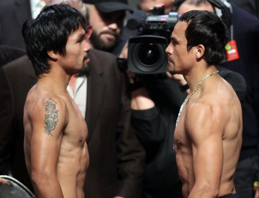 Manny Pacquiao (L) of the Philippines faces Juan Manuel Marquez (R) of Mexico during their weigh-in Manny Pacquiao (L) of the Philippines faces Juan Manuel Marquez (R) of Mexico during their weigh-in