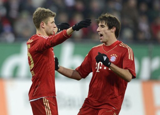 L-R: Bayern Munich's midfielder Javi Martinez and striker Thomas Mueller celebrate L-R: Bayern Munich's midfielder Javi Martinez and striker Thomas Mueller celebrate