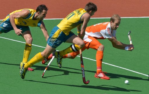 Captain Eddie Ockenden of Australia (centre) challenges Billy Baaker of the Netherlands Captain Eddie Ockenden of Australia (centre) challenges Billy Baaker of the Netherlands