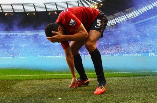 Rio Ferdinand was left bleeding after appearing to be struck in the face by an object thrown from the Etihad crowd Rio Ferdinand was left bleeding after appearing to be struck in the face by an object thrown from the Etihad crowd