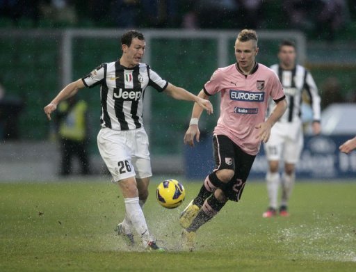 Juventus's Stephan Lichtsteiner (L) is challenged by Palermo's defender Jasmin Kurtic Juventus's Stephan Lichtsteiner (L) is challenged by Palermo's defender Jasmin Kurtic
