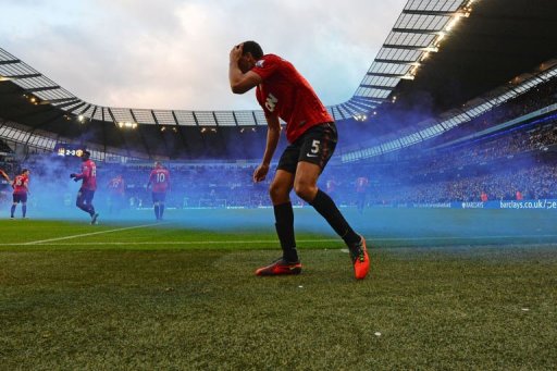 Rio Ferdinand reacts after being struck by a coin Rio Ferdinand reacts after being struck by a coin