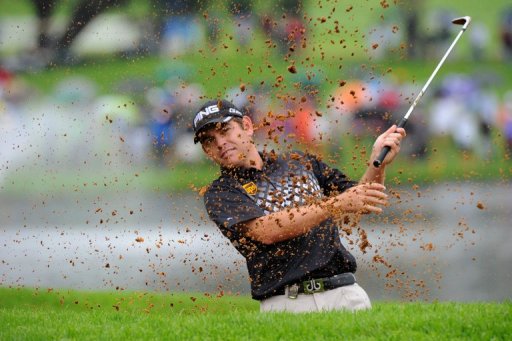 Louis Oosthuizen plays a shot out of a bunker on the 18th during the Nedbank Golf Challenge in Sun City on December 2 Louis Oosthuizen plays a shot out of a bunker on the 18th during the Nedbank Golf Challenge in Sun City on December 2