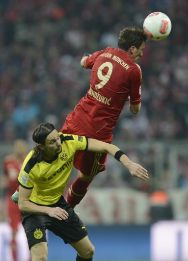 Bayern striker Mario Mandzukic outjumps Dortmund's Neven Subotic during the German Bundesliga match on December 1, 2012 Bayern striker Mario Mandzukic outjumps Dortmund's Neven Subotic during the German Bundesliga match on December 1, 2012