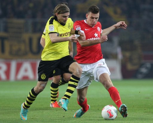 Mainz striker Adam Szalai (R) and Dortmund defender Marcel Schmelzer tussle in the Bundesliga on November 24, 2012 Mainz striker Adam Szalai (R) and Dortmund defender Marcel Schmelzer tussle in the Bundesliga on November 24, 2012
