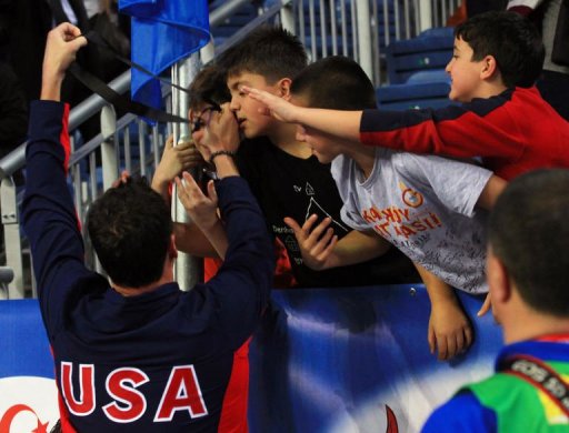 Ryan Lochte (L) of USA gives his medal to a Turkish child, Arda Cakmak (2ndL) Ryan Lochte (L) of USA gives his medal to a Turkish child, Arda Cakmak (2ndL)