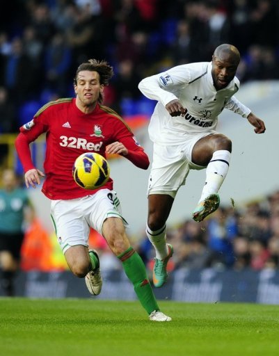 Tottenham defender William Gallas clears the ball from Swansea forward Michu at White Hart Lane on December 16, 2012 Tottenham defender William Gallas clears the ball from Swansea forward Michu at White Hart Lane on December 16, 2012