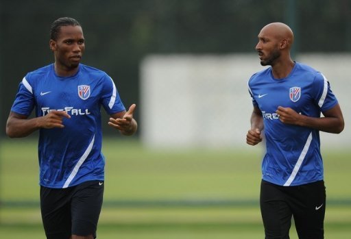 Shanghai Shenhua players Didier Drogba (L) and Nicolas Anelka warm up during a training session on July 16, 2012 Shanghai Shenhua players Didier Drogba (L) and Nicolas Anelka warm up during a training session on July 16, 2012