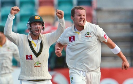 Australia's Peter Siddle (R) celebrates with Phil Hughes after dismissing Thilan Samaraweera on December 18, 2012 Australia's Peter Siddle (R) celebrates with Phil Hughes after dismissing Thilan Samaraweera on December 18, 2012