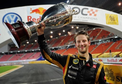 French F1 driver Romain Grosjean celebrates with the trophy after winning the Race of Champions on December 16, 2012 French F1 driver Romain Grosjean celebrates with the trophy after winning the Race of Champions on December 16, 2012