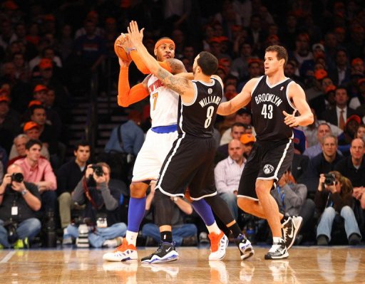 Carmelo Anthony (L) is blocked by the Nets' Deron Williams (C) and Kris Humphries during their game on December 19, 2012 Carmelo Anthony (L) is blocked by the Nets' Deron Williams (C) and Kris Humphries during their game on December 19, 2012