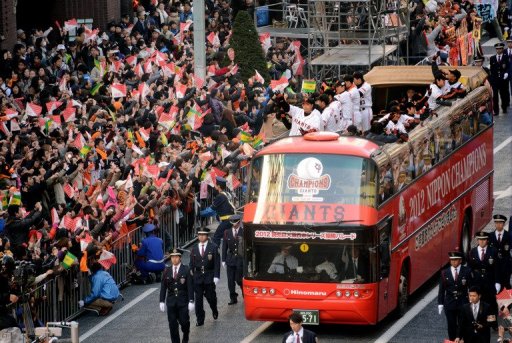 The Tokyo Yomiuri Giants wave to thousands of fans during a parade to celebrate their victory on November 25, 2012 The Tokyo Yomiuri Giants wave to thousands of fans during a parade to celebrate their victory on November 25, 2012