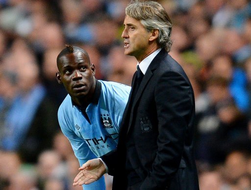 Manchester City manager Roberto Mancini (R) speaks to striker Mario Balotelli during a match on October 3, 2012 Manchester City manager Roberto Mancini (R) speaks to striker Mario Balotelli during a match on October 3, 2012