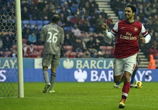 Arsenal's midfielder Mikel Arteta (R) celebrates scoring the opening goal in Wigan, England on December 22, 2012 Arsenal's midfielder Mikel Arteta (R) celebrates scoring the opening goal in Wigan, England on December 22, 2012