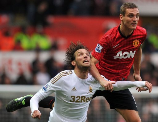 Manchester United's Nemanja Vidic vies with Swansea's Miguel Michu (left) Swansea, South Wales, December 23, 2012 Manchester United's Nemanja Vidic vies with Swansea's Miguel Michu (left) Swansea, South Wales, December 23, 2012