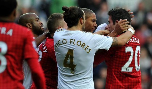Swansea's Ashley Williams (2nd right) and Manchester United's Robin van Persie clash in Swansea on December 23, 2012 Swansea's Ashley Williams (2nd right) and Manchester United's Robin van Persie clash in Swansea on December 23, 2012
