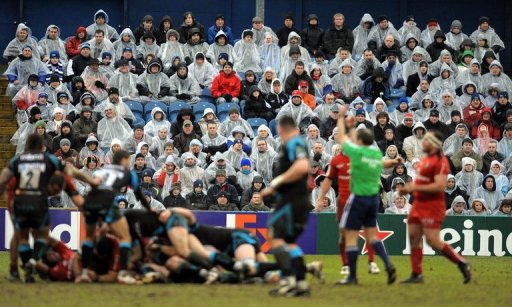Fans watch in the rain as the Sale Sharks play Toulouse in Stockport, England on January 24, 2010 Fans watch in the rain as the Sale Sharks play Toulouse in Stockport, England on January 24, 2010