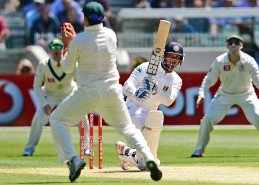 Kumar Sangakkara drives a ball at Australian fielder Ed Cowan (2nd L) in the second Test on December 26, 2012 Kumar Sangakkara drives a ball at Australian fielder Ed Cowan (2nd L) in the second Test on December 26, 2012