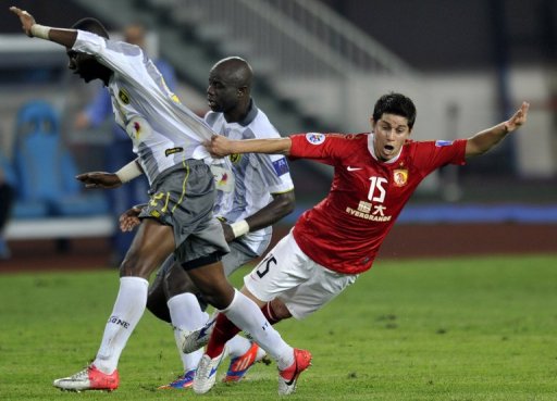 Guangzhou Evergrande's Dario Conca takes a tumble in an AFC Champions League clash on October 2, 2012 Guangzhou Evergrande's Dario Conca takes a tumble in an AFC Champions League clash on October 2, 2012